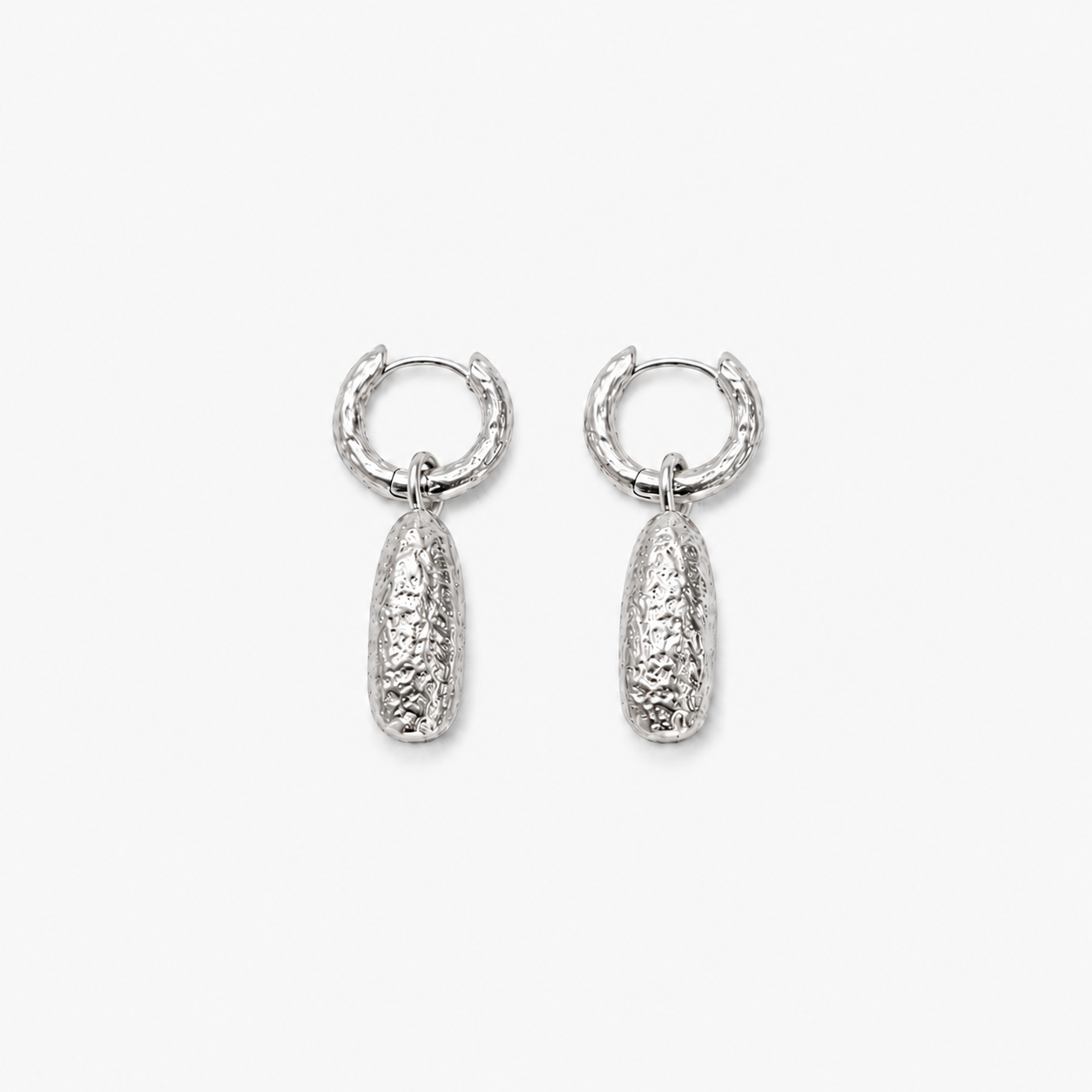 MUTESCENE Object Drop Hoops in a quiet silver-tone study