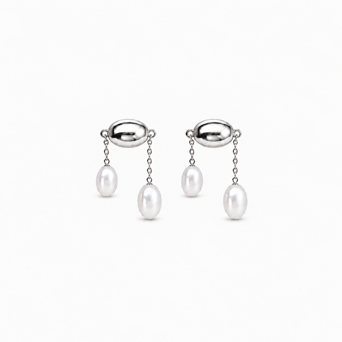 Still Fall Earrings — light neutral background, collection-safe framing with natural shadow