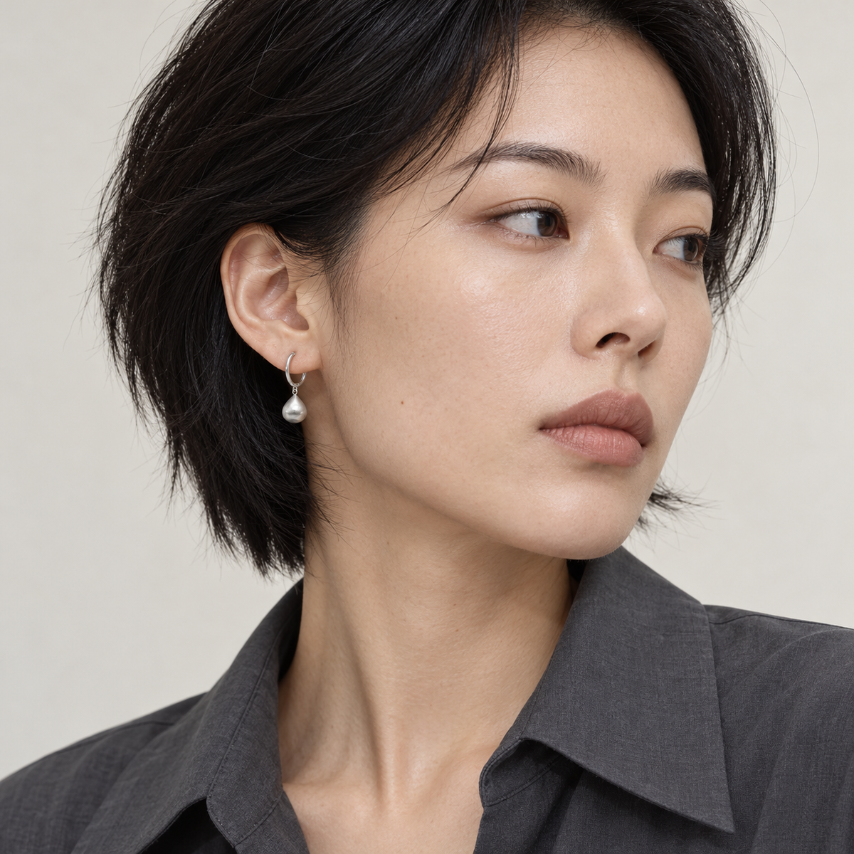 Whisper Earrings worn in a three-quarter editorial portrait
